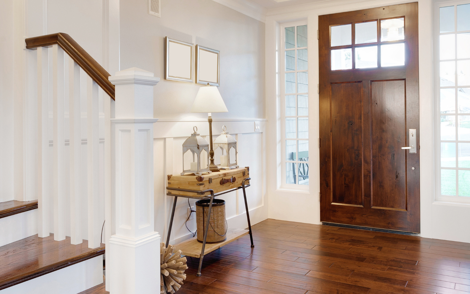 A front entryway of modern home with a wood entry door