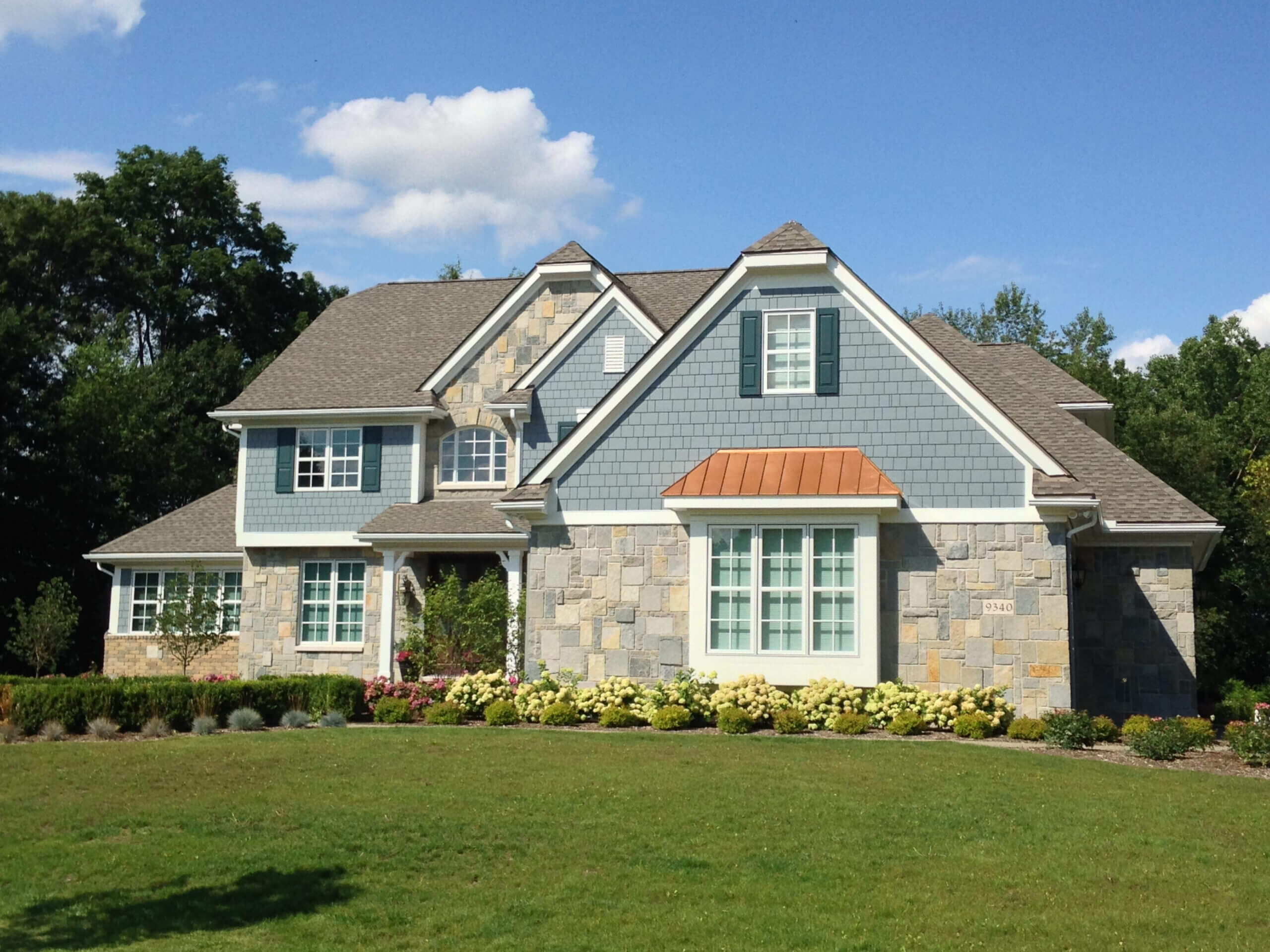 blue house with manufactured stone